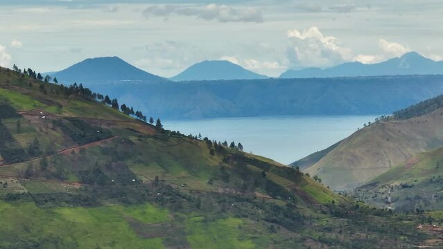 Lake Toba and the coast of Samosir Island. Tropical landscape. Sumatra, Indonesia.