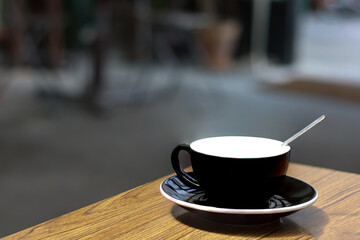 A dark cup of coffee. Space for text.