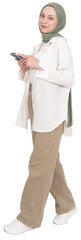 Using smartphone, full body view young caucasian muslim woman wear hijab abaya using smartphone. Walking holding mobile phone, looking camera. Isolated transparent  png image. Copy space.