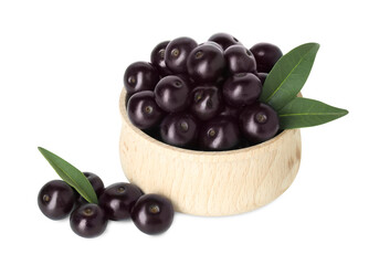 Fresh ripe acai berries in bowl and green leaves isolated on white