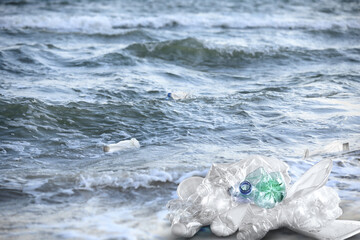 Sea with plastic garbage outdoors. Environmental pollution