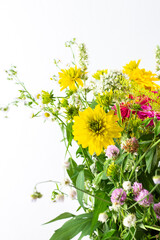 Summer bouquet of colorful Zinnia, onion inflorescences and mint sprigs, Rudbeckia Goldquelle and red clover, Ranunculus and Matricaria, home decoration with flowers