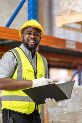 African American worker in warehouse, International export business concept. Industrial driver working at factory warehouse. Factory worker male showing thumb up on forklift. Paper factory.