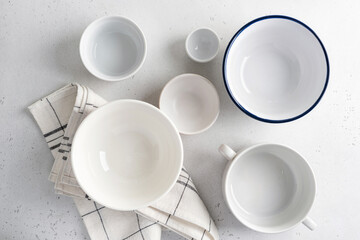 A stylish collection of minimalist ceramic bowls beautifully arranged on a clean white surface. Top view, copy space