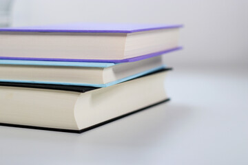 Close up mock up books stack on white table with copy space
