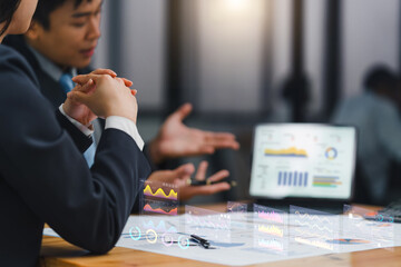 Business professionals using futuristic technology to analyze data and charts in a collaborative meeting, enhancing productivity and insights.