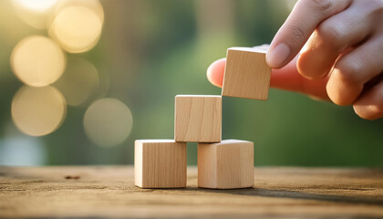 hand stacking wooden cubes