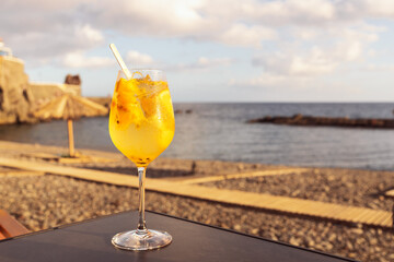 Refreshing cocktail with ice at the beach bar before the sunset. Summer drink