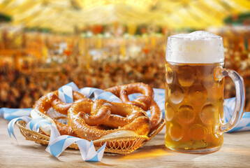 Mug of beer and basket of pretzels on tent beer background. Oktoberfest, beer festival