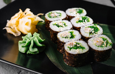 Elegant sushi roll display on black plate