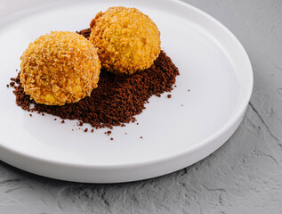 Gourmet truffles on white plate with cocoa dusting