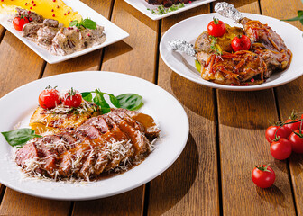 Gourmet feast: variety of dishes on wooden table
