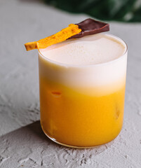 Tropical mango cocktail with chocolate garnish
