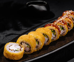 Exquisite sushi platter on dark slate background