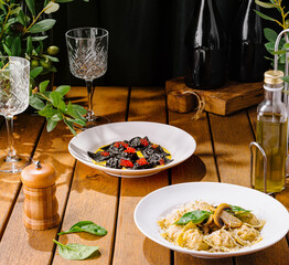 Gourmet italian pasta dishes on rustic wooden table