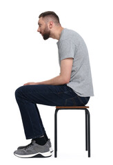 Man with poor posture sitting on chair against white background