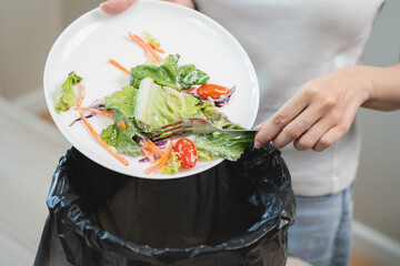 Compost from leftover food in the meal in household, female hand holding left over meal use fork...
