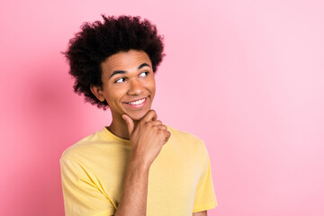 Photo of smart minded creative man arm touch chin toothy smile look empty space isolated on pink...