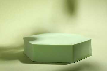 Presentation of product. Podium and shadows on light green background. Space for text