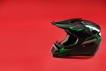 Modern motorcycle helmet with visor on red background. Space for text