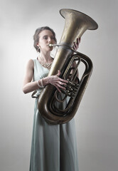 young woman plays a trombone