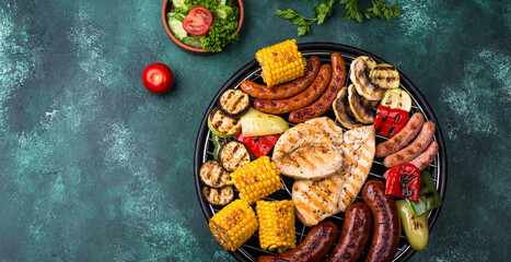 Grilled sausages, meat, and vegetables.
