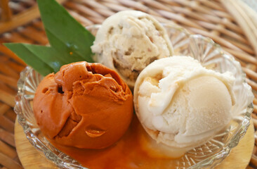 Closeup of Three Scoops of Sweetened Thai Tea and Coconut Milk Ice Cream in a Glass Bowl