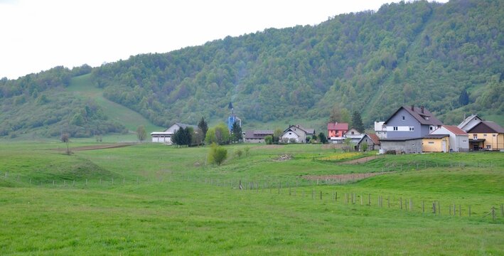 Green meadow and panoramic view on village Mrkopalj in Gorski kotar area in Croatia. Forest in Mrkopalj. Forest and Fields, photographed at spring day.