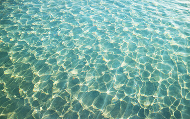 Artistic patterns of water surface in the pool reflecting with sunlight