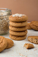 A stack of oatmeal cookies, a jar of oatmeal. Healthy dietary oatmeal cookies.
