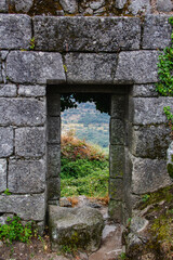 Door overlooking a landscape on ancient stones. Travel.