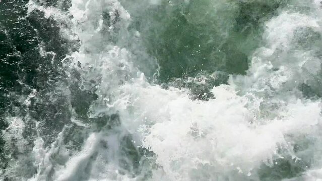Wild swell in the sea during a stormy water droplets and splashes foam in the swirl waves.