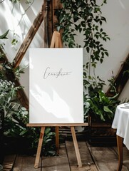 a large oversized white blank welcome sign resting on a wooden easel, inside a wedding venue