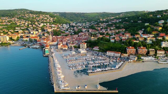 An aerial sunset view of the charming town of Muggia in Friuli Venezia Giulia, Italy with white mucilaginous blooms blanket. This picturesque town, located near the border with Slovenia 