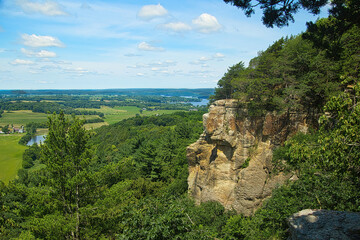 Sunny Summer day landscape of the view from the top of Gibraltar Rock of surrounding forests and farmland with Lake Wisconsin in the distance, near Lodi, Wisconsin.