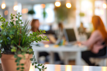Modern Office with Blurred Employees Working and Focus on Green Plant in Foreground