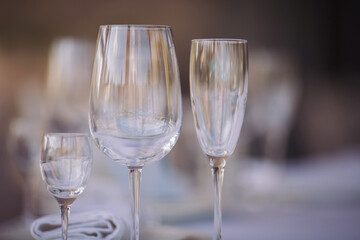 Beautiful table setting with crockery  for a party, wedding reception or other festive event. Glassware and cutlery for catered event dinner. Beautiful table set for some festive event