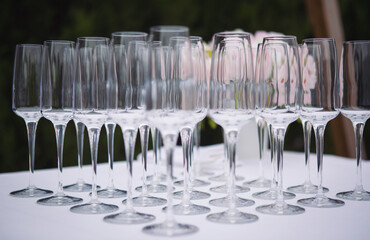 A lot of empty wine glasses. wineglass wedding. Empty glasses arranged on a table in the restaurant, cafe, or bar. Preparation for the birthday, wedding, or any celebration day.