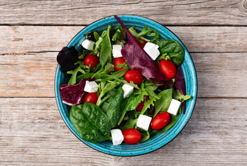Summer salad with arugula, spinach, cherry tomatoes and cheese feta