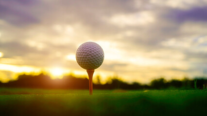 golf ball on tee in beautiful golf course with sunset. Golf ball close up in golf coures.