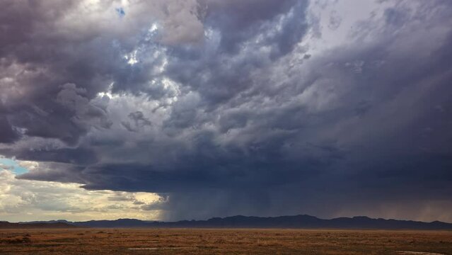Summer storm timelapse rolling over the Utah Desert as it rains in the distance.