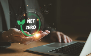 Entrepreneur hand point at Net zero text while control and reduce carbon emission for global friendly business or ESG. Business with environment concern, carbon credit and zero emission.