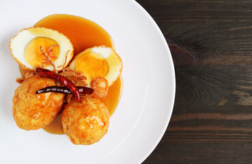 Famous Thai Homemade Dish of Kai Look Keuy or Son In Law Eggs on Wooden Table