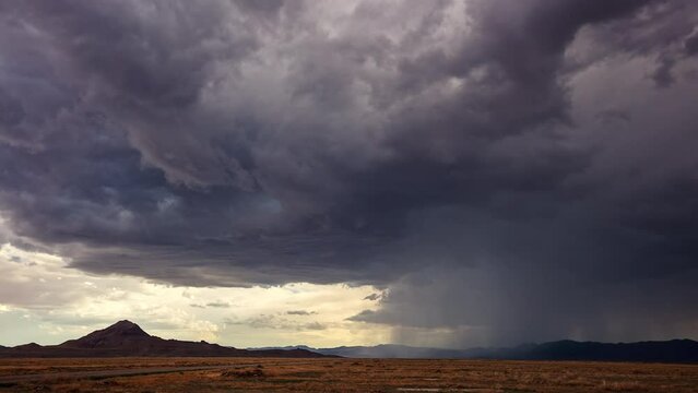 Timelapse of a rainstorm moving over the Utah desert as dramatic clouds roll through the sky.