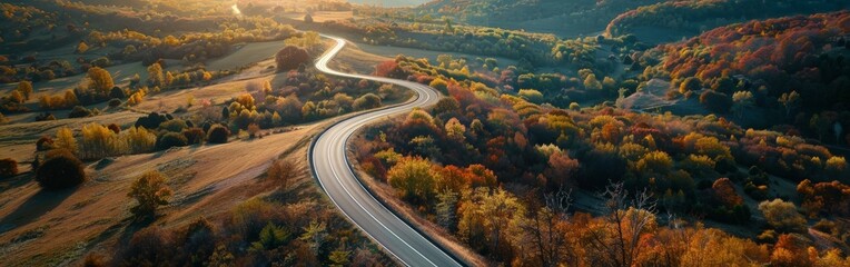 Aerial View of Highway Curving Through Autumn Hills