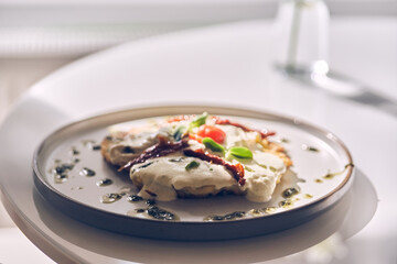 Potato pancakes with white garlic sauce. Healthy breakfast in the restaurant. With space to copy. High quality photo