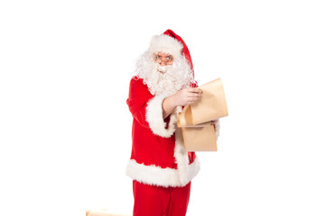 Funny Santa Claus reads mail with wishes. White background.