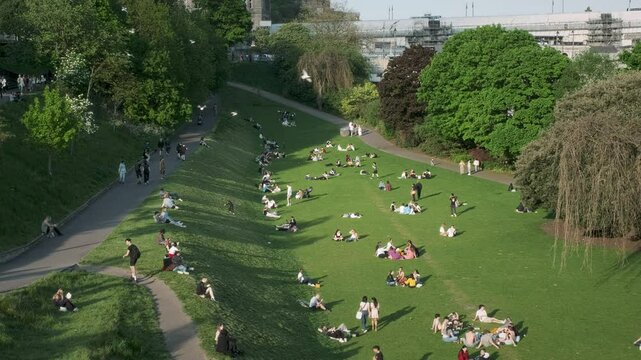 Edinburgh, United Kingdom May 11, 2024. Many people relax on the grass at Princes Street Gardens on the first warm days after winter. 