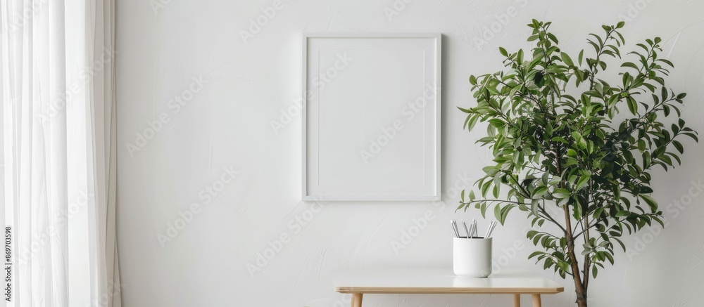 Fototapete Table with a houseplant next to a photo frame on a white wall with a space for images. Copy space image. Place for adding text and design