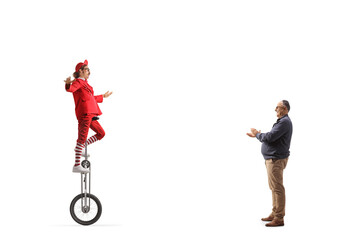 Mature man giving applause to an acrobat riding a giraffe unicycle © Ljupco Smokovski